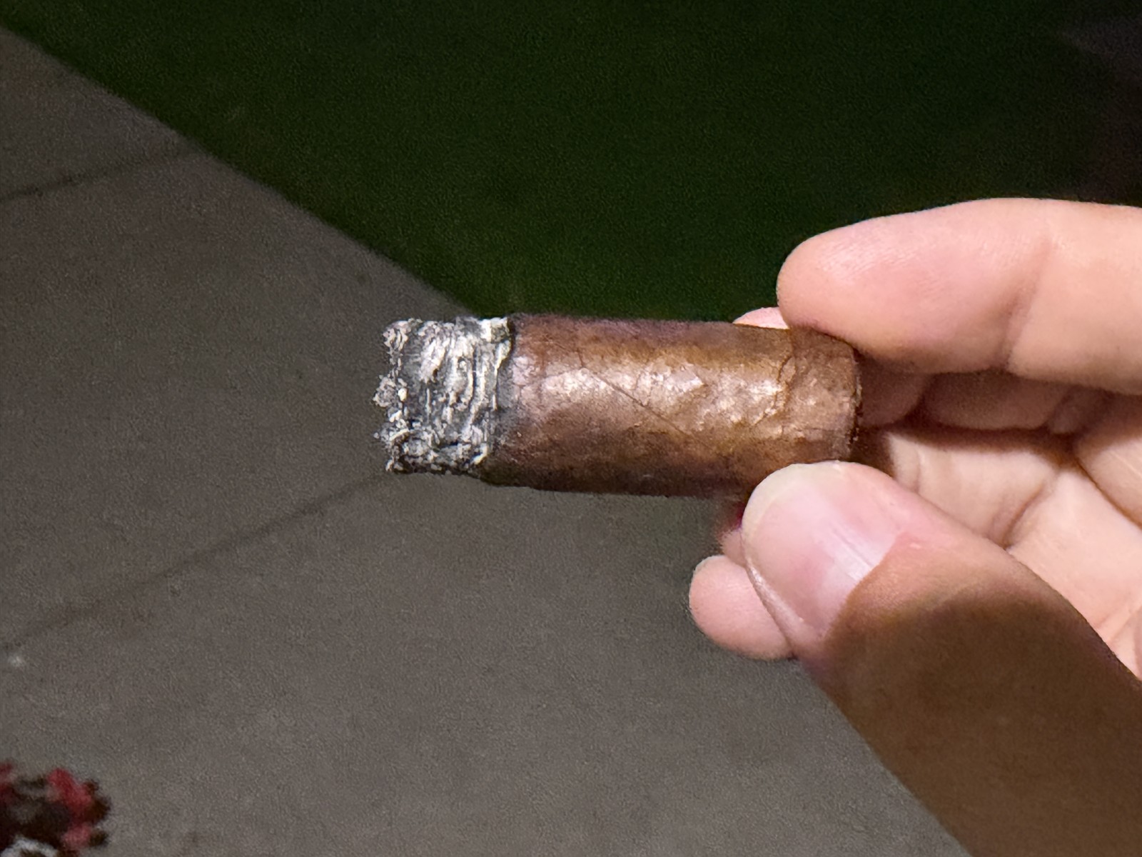 Mil Días Maduro down to the nub with the band off at night