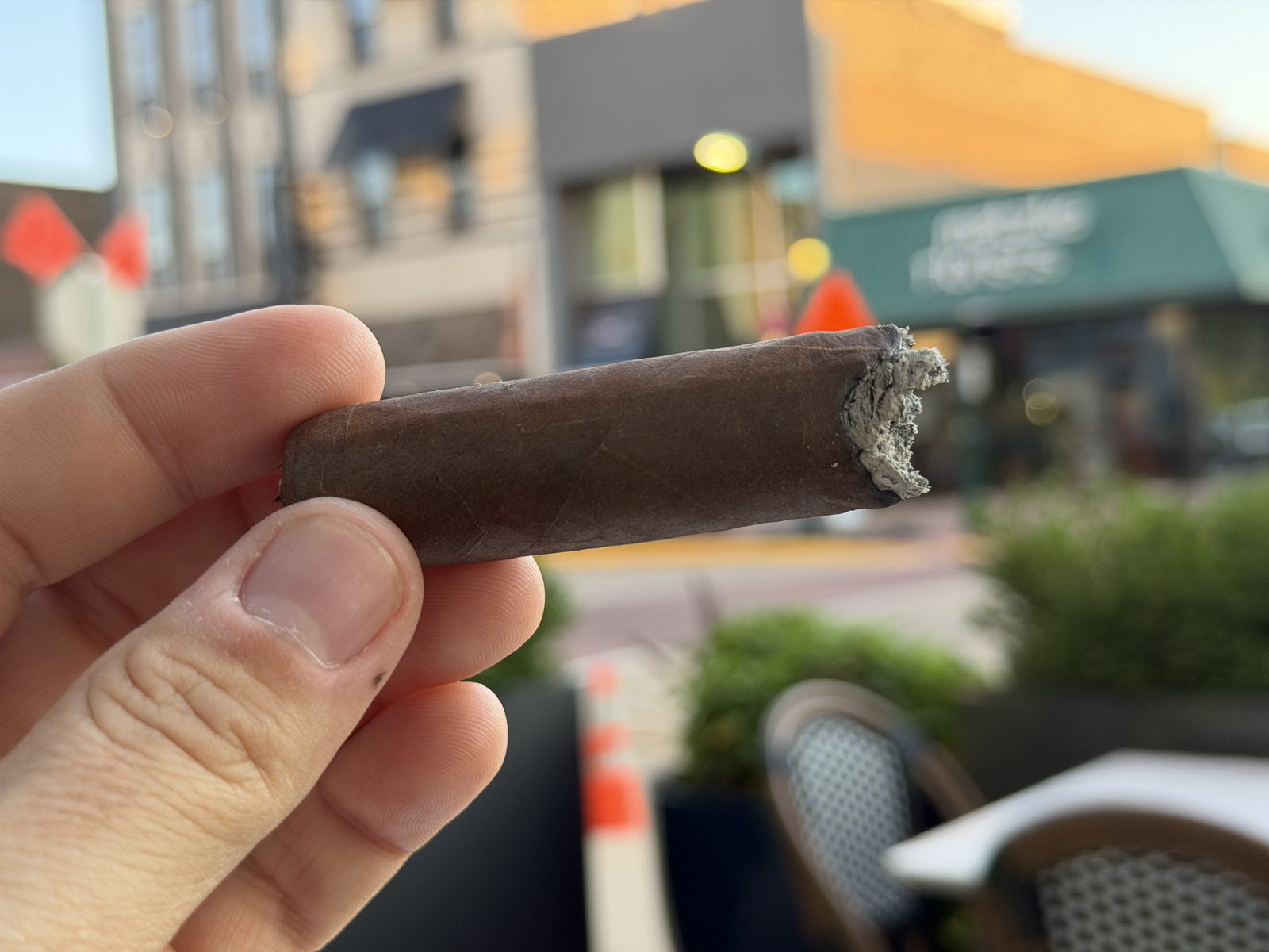 Diesel Whiskey Row Toro past the midpoint with the band off, showing a slightly ragged burn line and fresh ash