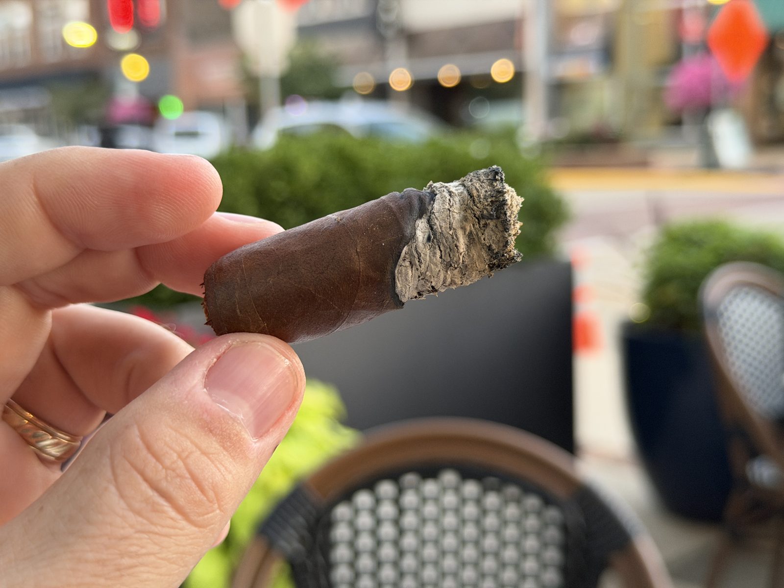 Nub of the Diesel Whiskey Row Toro with craggy ash and a visibly uneven burn, one side of the wrapper running long