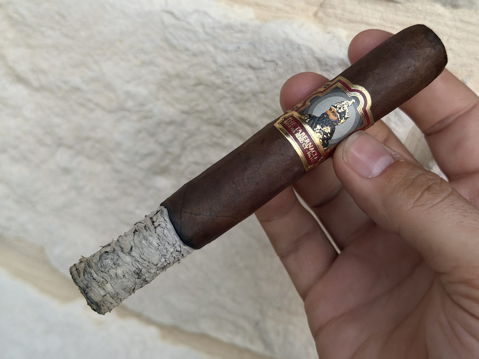 Tabernacle 142 Toro in hand with a pale flaky ash stack and the band still on