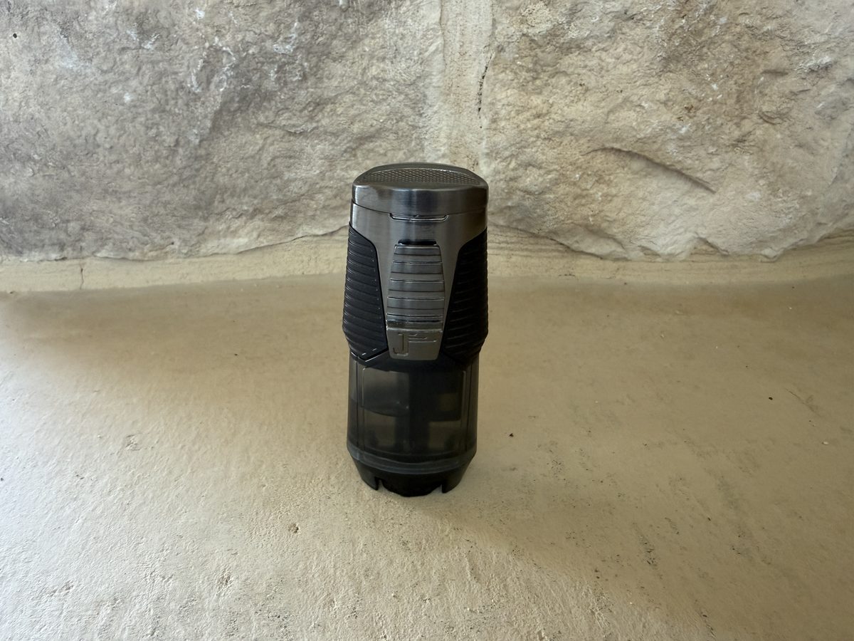 Front view of the closed Jetline Rubanno standing upright, brushed gunmetal metal top half over a smoked plastic fuel tank, ribbed ignition paddle with the Jetline J