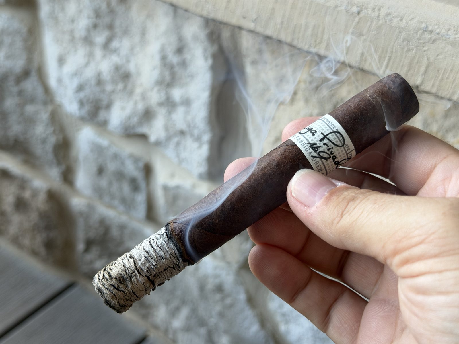 Liga Privada No. 9 Toro with a long tight white-gray ash stack and near razor-sharp burn line