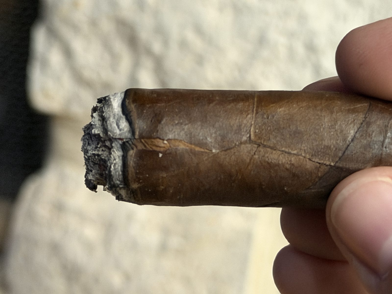 Close-up of a crack in the Le Bijou 1922 wrapper just below the burn line in the final third