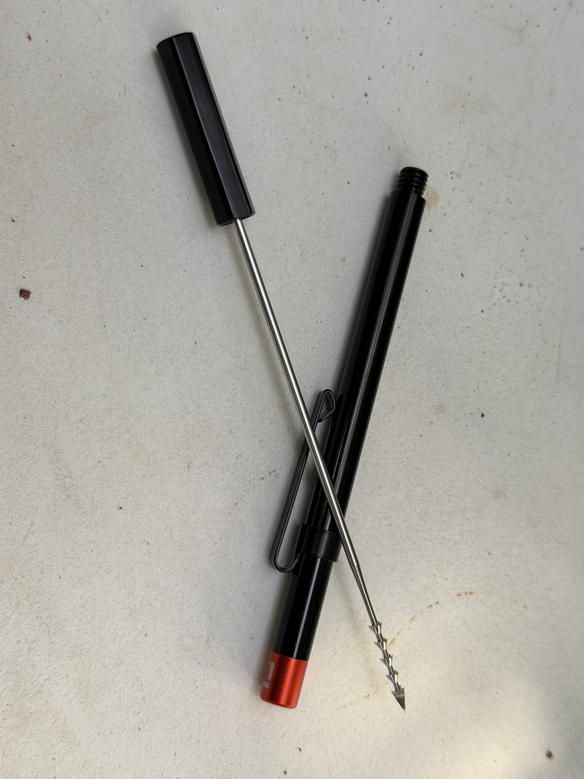 PerfecDraw unscrewed into two pieces, showing the stainless steel shaft with a corkscrew coil and pointed tip that clears the plug