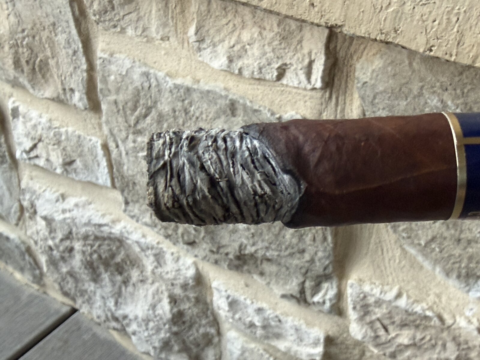 First-third ash on the Punch Reserve Collection Robusto, a tight dark-gray stack with visible ridging