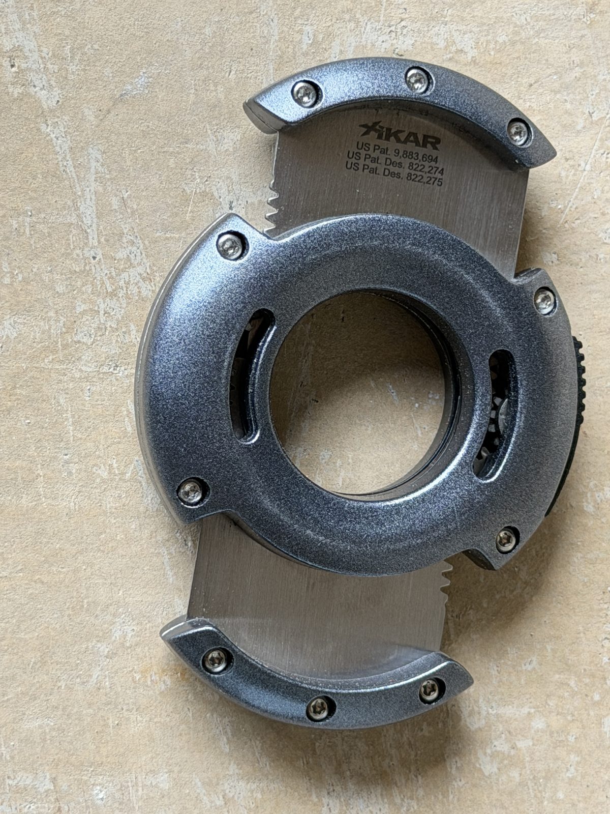 Xikar XO cutter open with both stainless blades extended evenly, Xikar branding and patent markings visible